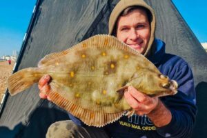 Steve with his stunning 51cm plaice, caught at range on frozen blacks using a bomber rig and grip lead